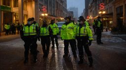 Police officers gather on a street during a protest by truck drivers over pandemic health rules and the Trudeau government, outside the parliament of Canada in Ottawa on February 17, 2022.