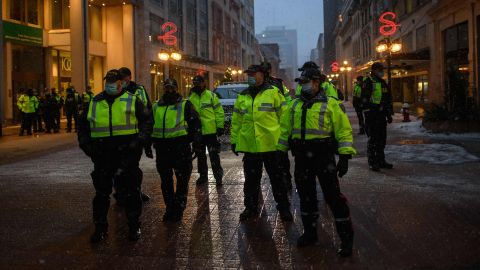 Police officers gather on a street during a protest over pandemic health rules outside the parliament of Canada in Ottawa on February 17, 2022.