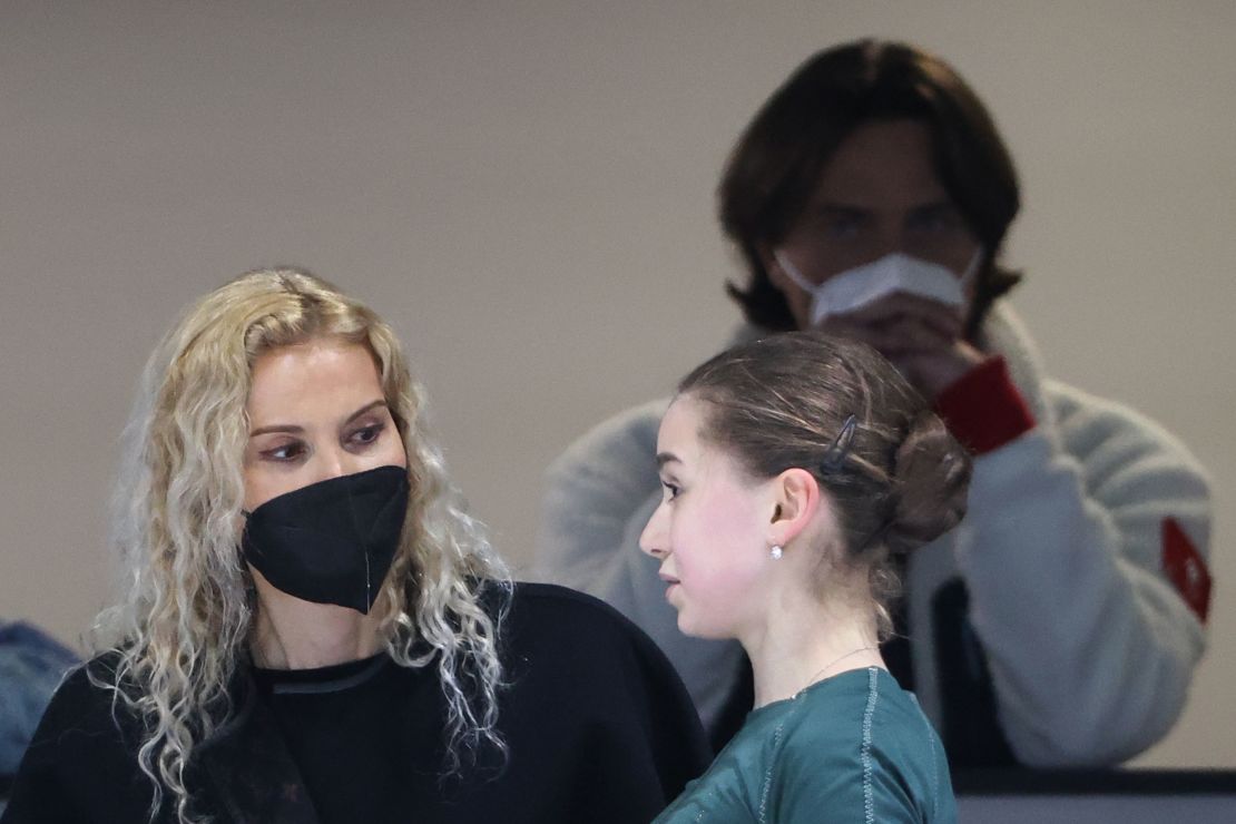 Kamila Valiyeva (R) talks to her coach Eteri Tutberidze during a training session in Beijing. Pictured behind them is ROC physician Filipp Shvetsky.