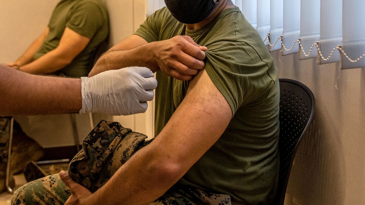  A US Marine prepares to receive the Moderna coronavirus vaccine at Camp Hansen on April 28, 2021, in Kin, Japan. 