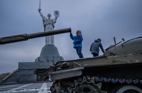 Children play on old Soviet tanks in front of the Motherland Monument in Kyiv, Ukraine, on Wednesday, February 16.