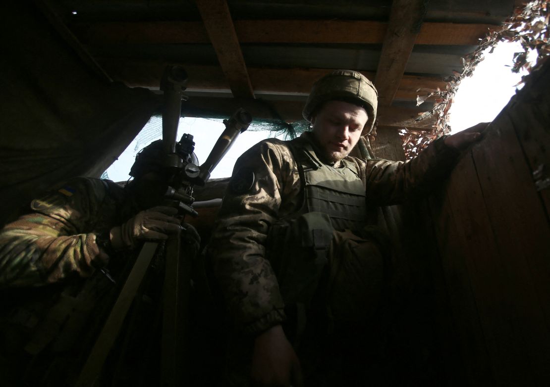 A Ukrainian serviceman looks through a spyglass on the front line with Russia-backed separatists, near Novolugansk, in the Donetsk region, on February 17, 2022. 