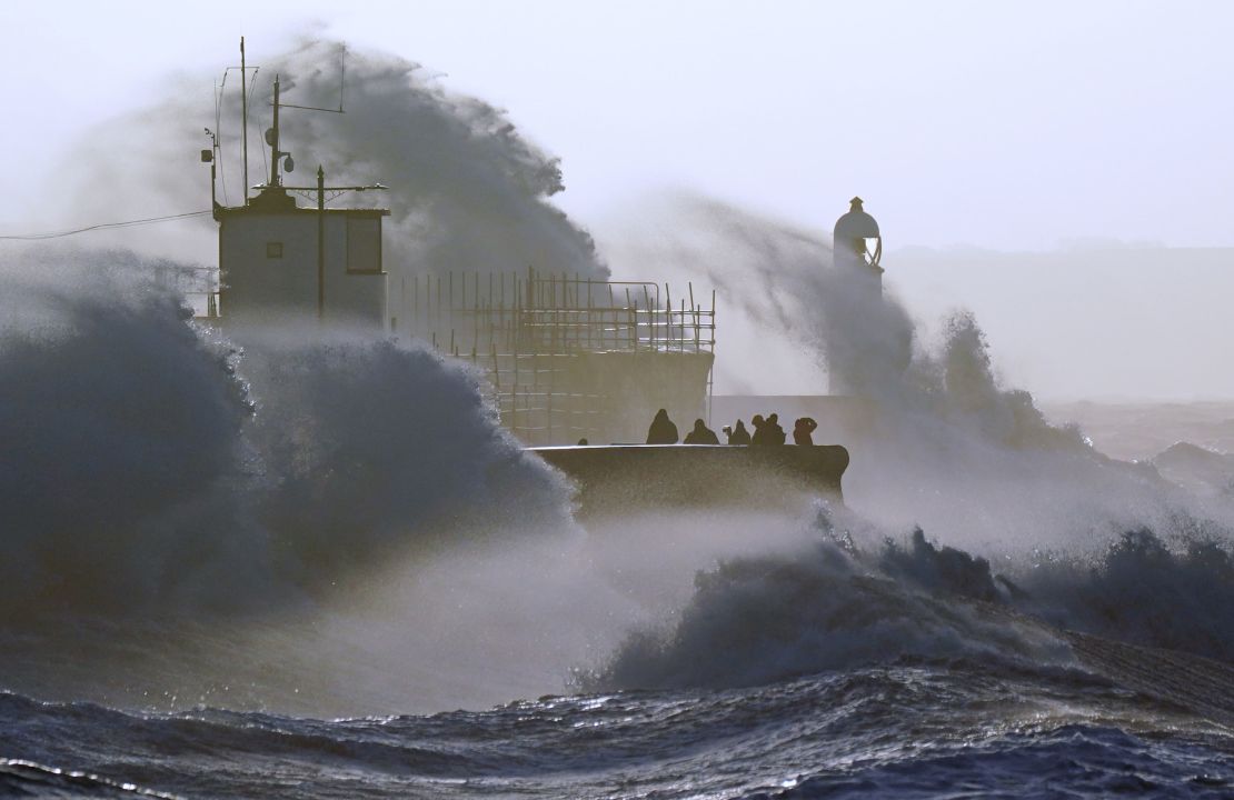 Waves crash against the sea wall and Porthcawl Lighthouse in Bridgend, Wales, as Storm Eunice hits the UK on Friday. 
