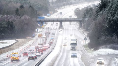 Motorists drive through the sleet and snow along the M8 motorway near Bathgate in West Lothian as Storm Eunice sweeps across the UK after hitting the south coast earlier on Friday.