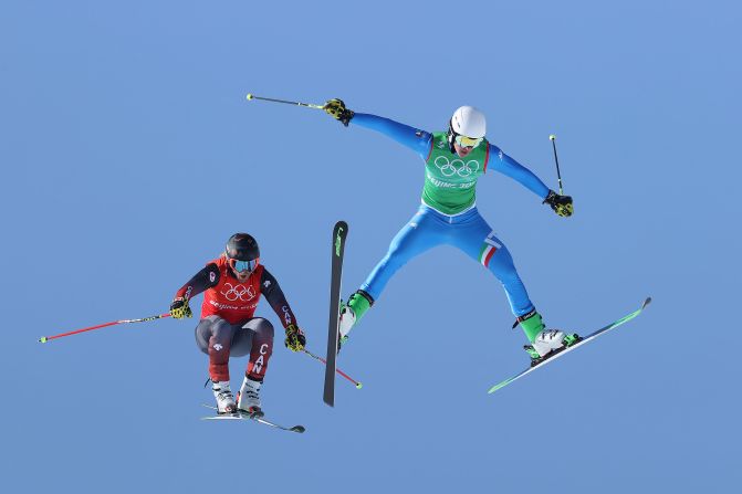 Canada's Brady Leman, left, and Italy's Simone Deromedis fly through the air during a ski cross race on February 18.