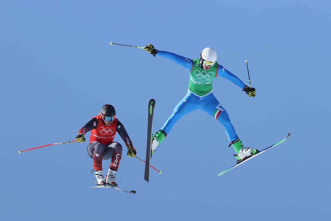 Canada's Brady Leman, left, and Italy's Simone Deromedis fly through the air during a ski cross race on February 18.