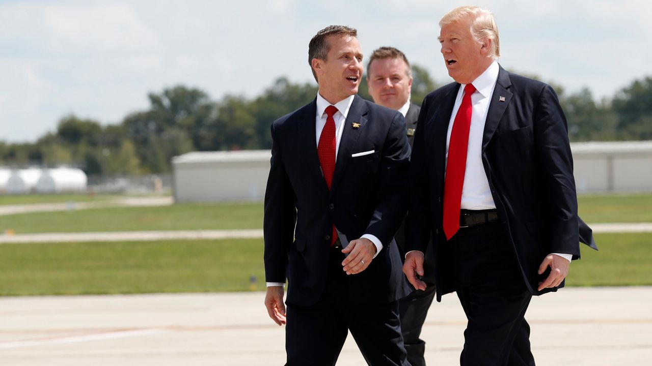 Then-Gov. Eric Greitens, at left, walks with then-President Donald Trump as they arrive in Springfield, Missouri in August 2017.