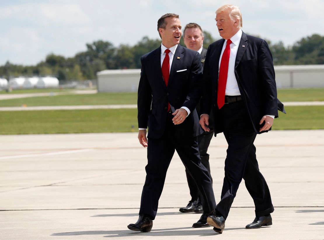 Then-Gov. Eric Greitens, at left, walks with then-President Donald Trump as they arrive in Springfield, Missouri in August 2017. 