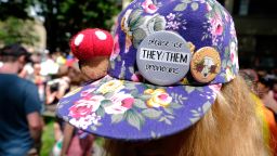 A person wears a pronouns pin on their hat at a Trans Pride March in Portland, Oregon, on June 16, 2018. 