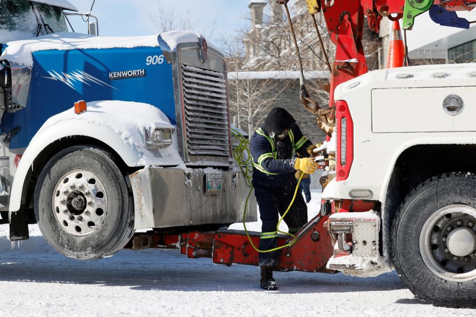 A man prepares a truck for towing in Ottawa on February 18.