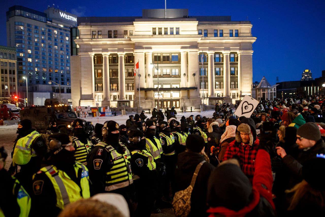 Police officers form a line as they push back protesters on February 18.
