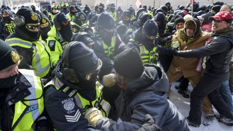 Law enforcement officers confront protesters during a demonstration in Ottawa on Friday.