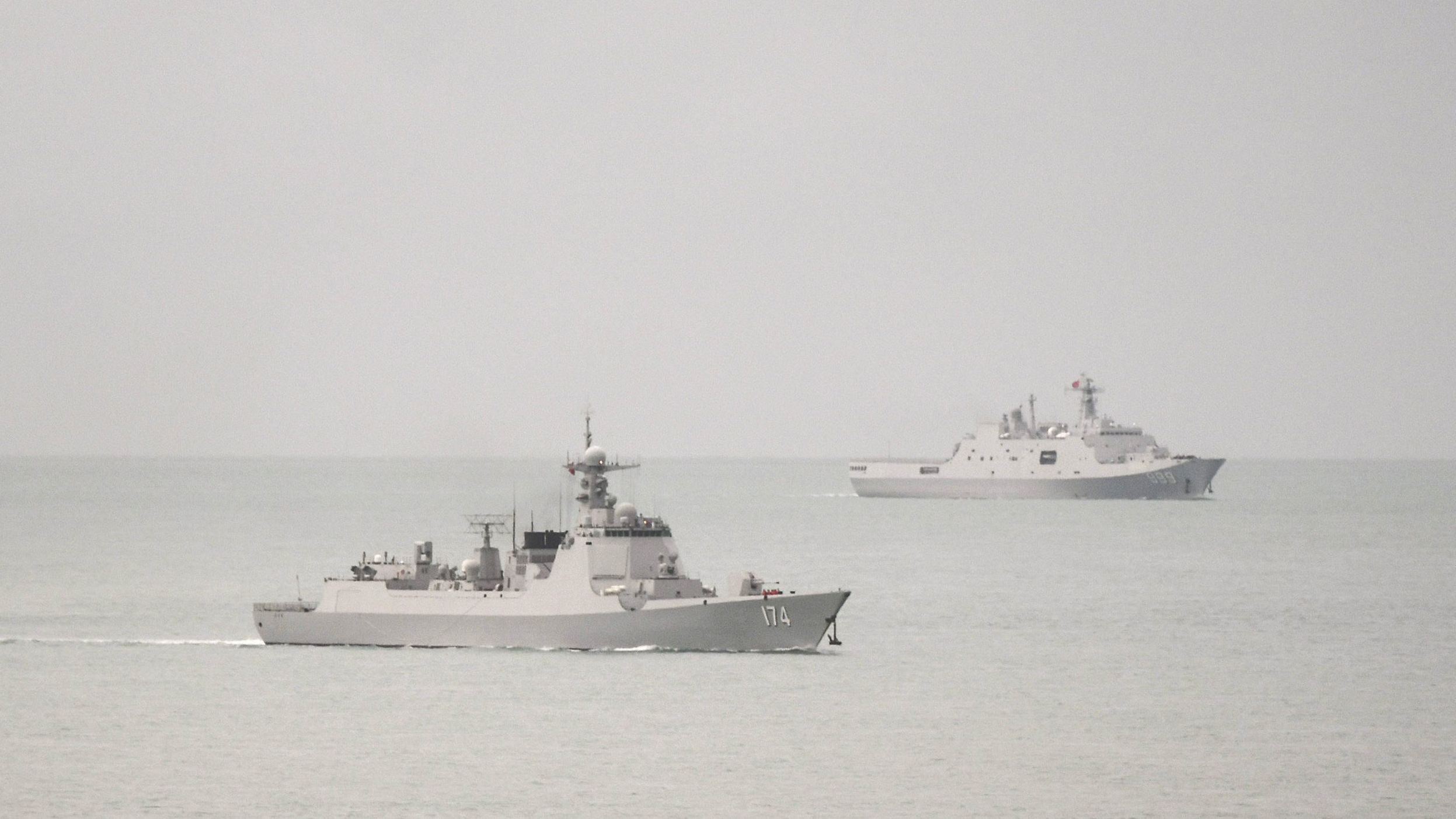 Two Chinese People's Liberation Army warships are seen in an image released by the Australian military after it said one of the ships endangered an Australian plane with a laser.