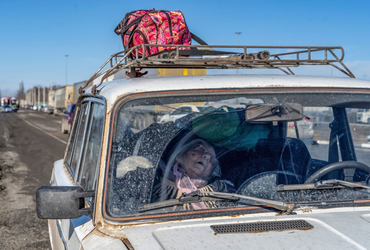 A woman rests in a car near a border checkpoint in Avilo-Uspenka, Russia, on February 19.  Zelensky says Russia waging war so Putin can stay in power &#8216;until the end of his life&#8217; w 1280