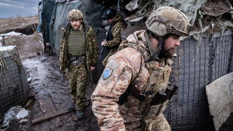 Ukrainian Interior Minister Denys Monastyrskiy, left, visits soldiers at a front-line position in Novoluhanske on February 19. Minutes after he left, the position came under fire. No one was injured.