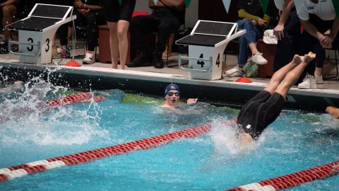 Lia Thomas observes the action in the pool after completing the first leg of the 800-yard freestyle relay on Wednesday.