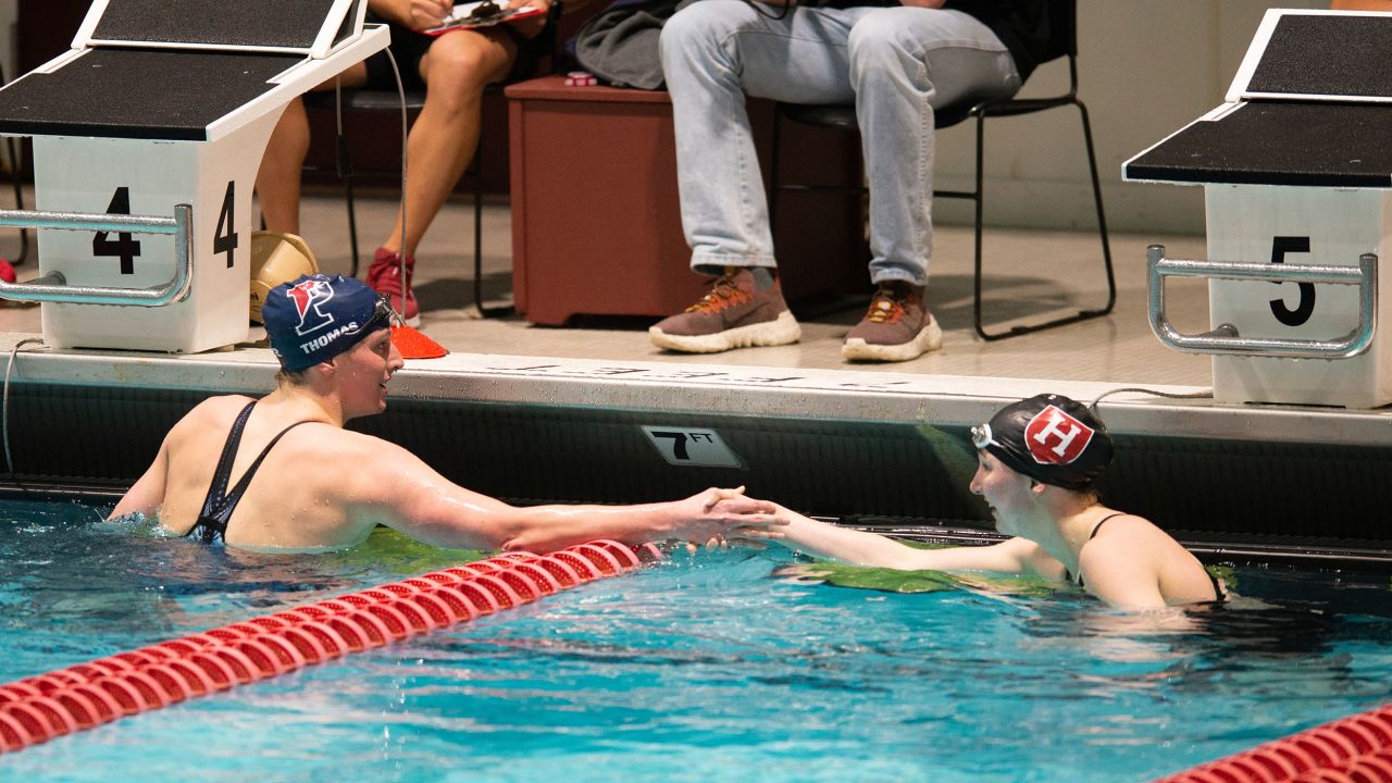 Lia Thomas shakes the hand of Harvard University swimmer Molly Hamlin following the 200-yard freestyle on Friday.