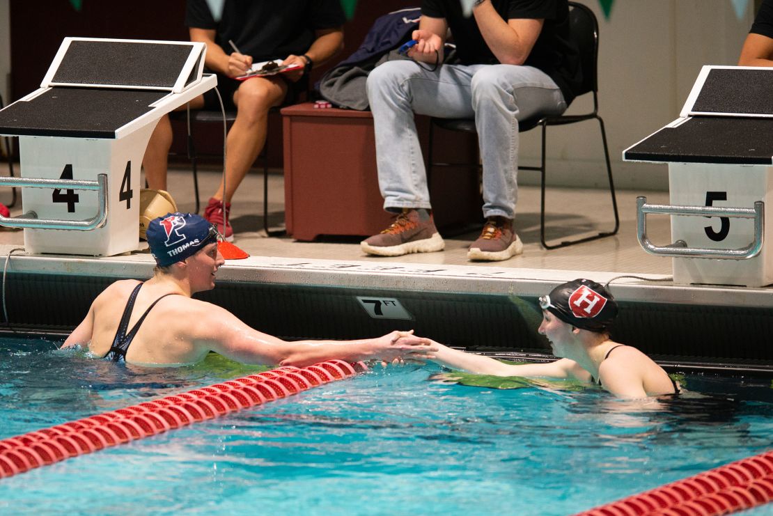 Lia Thomas shakes the hand of Harvard University swimmer Molly Hamlin following the 200-yard freestyle on Friday.
