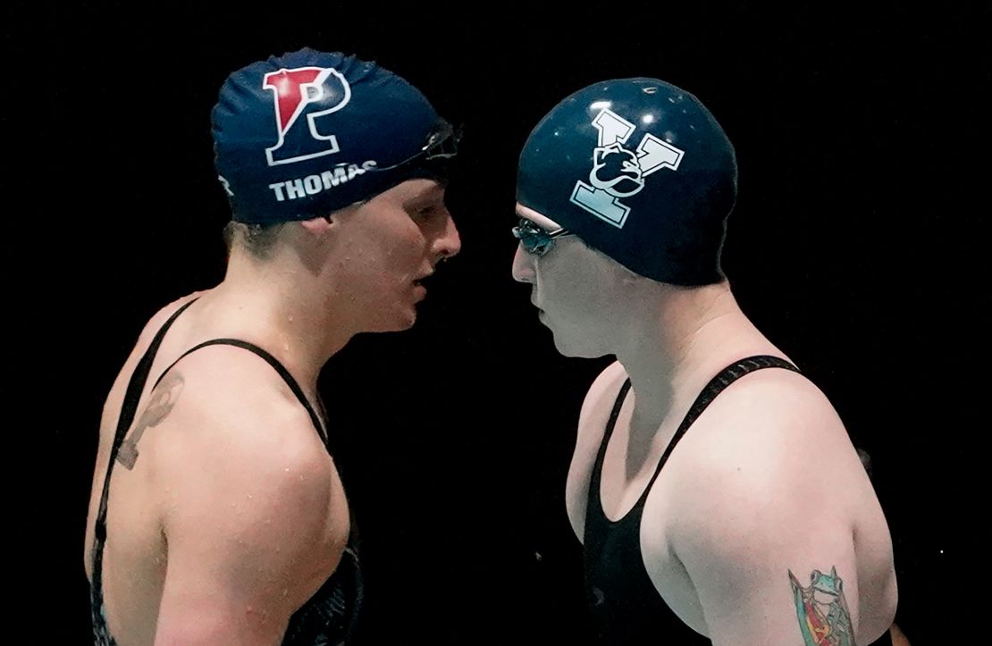 Lia Thomas, left, and Yale's Iszac Henig, right, prepare to swim in a qualifying heat of the 100-yard freestyle on Saturday.