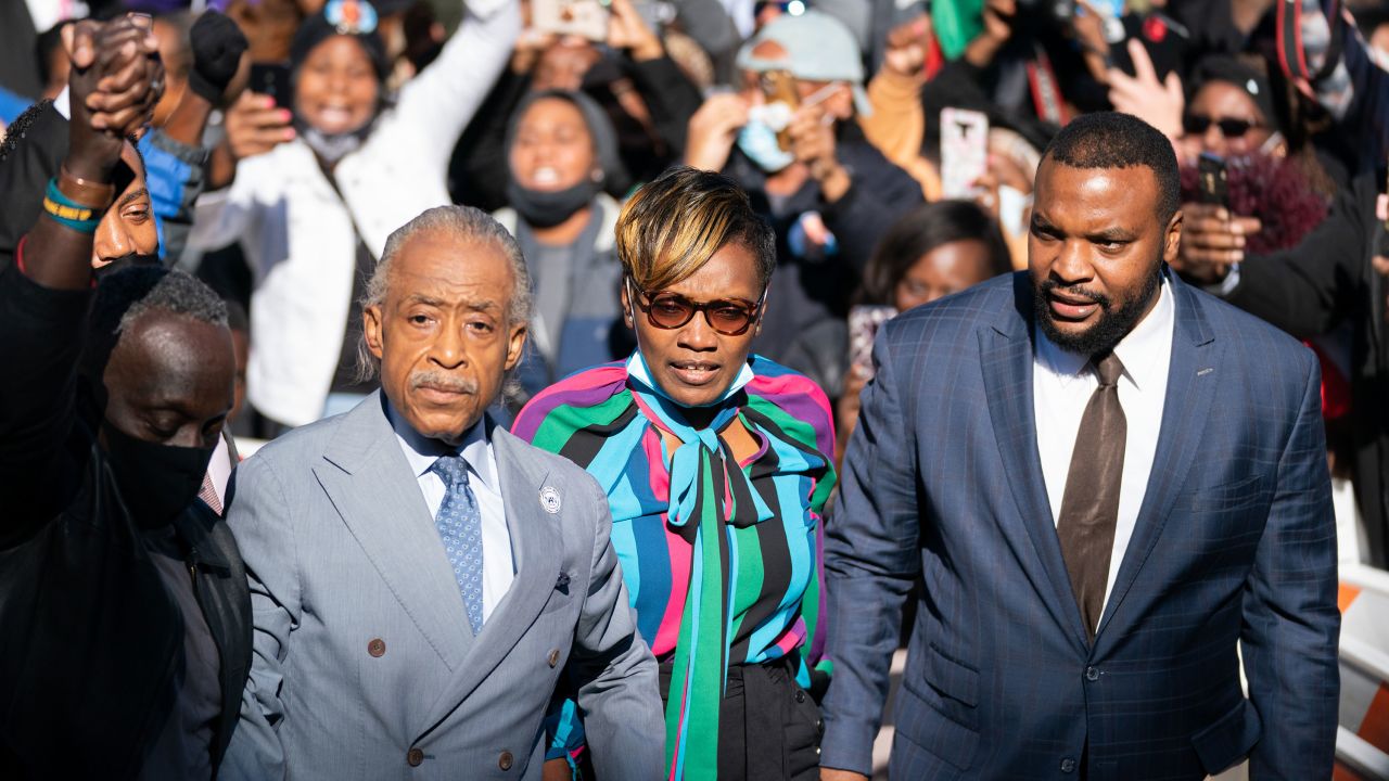 The Rev. Al Sharpton, left, is seen with Ahmaud Arbery's mother, Wanda Cooper-Jones, and attorney Lee Merritt outside the Glynn County Courthouse following guilty verdicts in the state trial for the three White men in Ahmaud Arbery's fatal shooting.