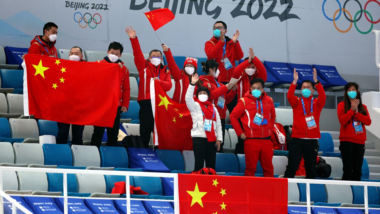Spectators cheer for Team China during a curling match the Beijing 2022 Winter Olympics.