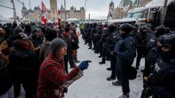 Police move in to clear protesters from downtown Ottawa near Parliament Hill on Saturday, Feb. 19, 2022.  Police resumed pushing back protesters on Saturday after arresting more than 100 and towing away vehicles in Canada's besieged capital, and scores of trucks left under the pressure, raising authorities' hopes for an end to the three-week protest against the country's COVID-19 restrictions. (Cole Burston/The Canadian Press/AP)