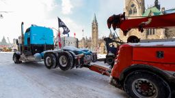 A truck is towed from in front of Parliament Hill as Canadian police work to restore normality to the capital after trucks and demonstrators occupied the downtown core for more than three weeks to protest against pandemic restrictions in Ottawa, Ontario, Canada, February 19, 2022. REUTERS/Patrick Doyle
