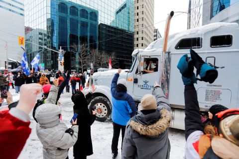 People show their support for a trucker as he leaves downtown Ottawa on February 19.