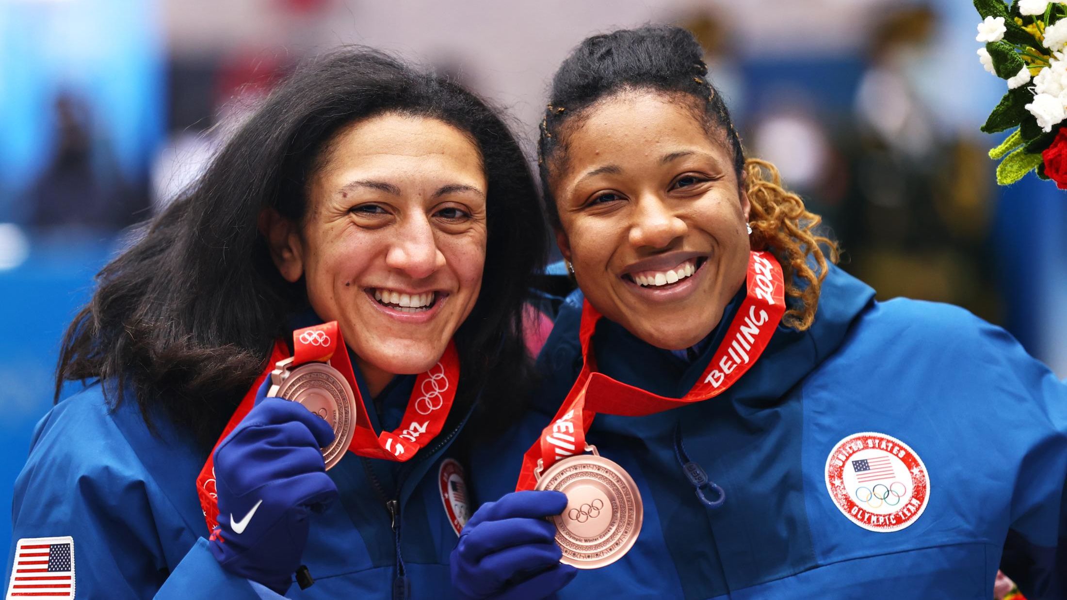 Bronze medal winners Meyers Taylor and Hoffman of Team United States pose for a photo during the flower ceremony.