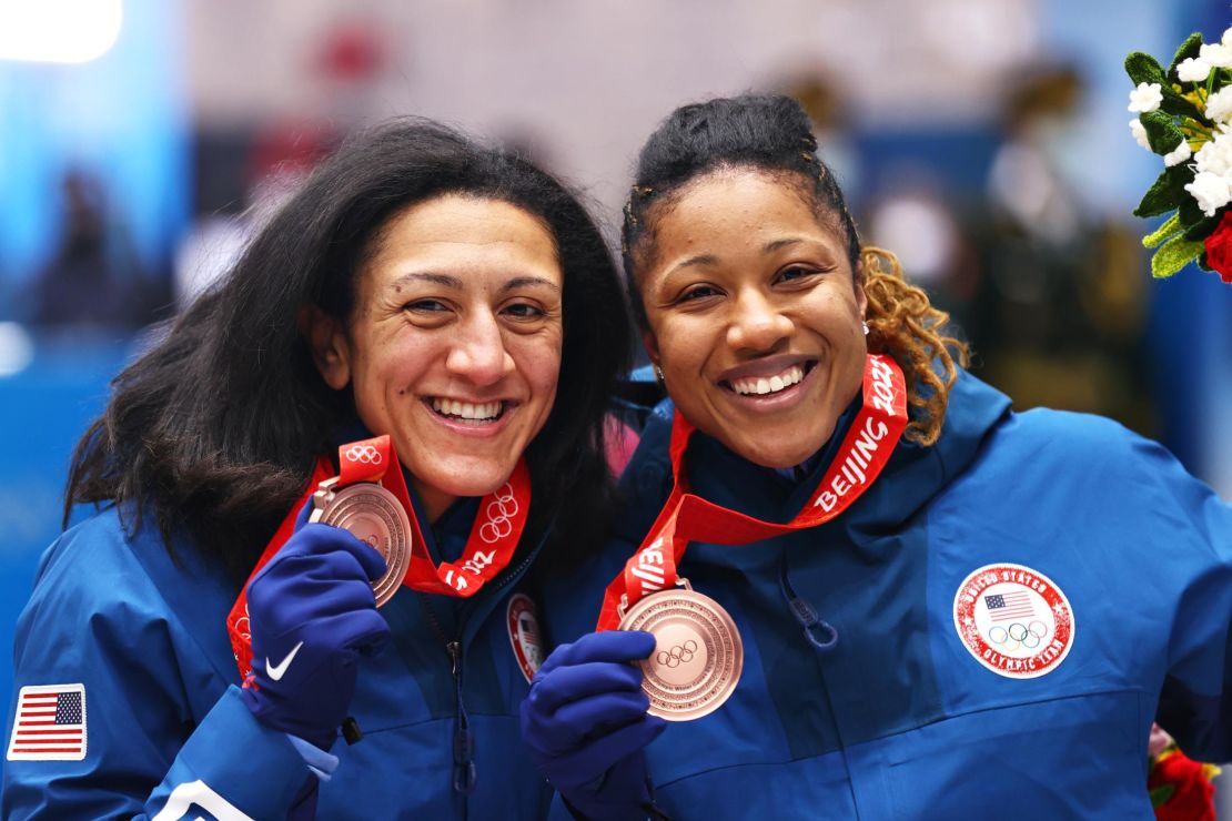 Bronze medal winners Meyers Taylor and Hoffman of Team United States pose for a photo during the flower ceremony.