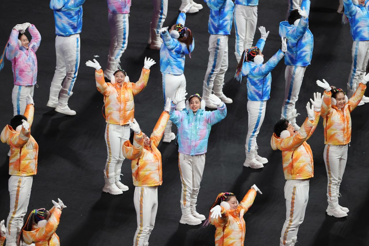 Performers wave during the closing ceremony.