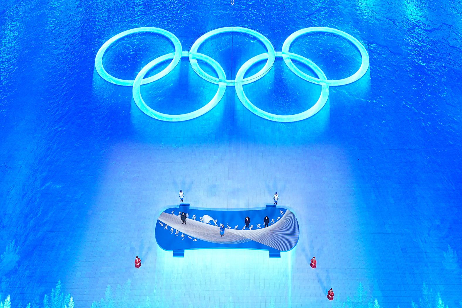 Thomas Bach, president of the International Olympic Committee, waves the Olympic flag during the ceremony. He passed the flag to the mayors of Milan and Cortina d'Ampezzo. Those cities will host the Winter Games in 2026.