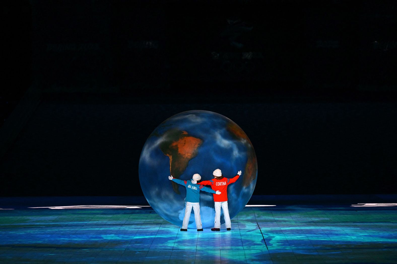 Children representing Milan and Cortina d'Ampezzo hug a globe as part of <a href="index.php?page=&url=https%3A%2F%2Fwww.cnn.com%2Fworld%2Flive-news%2Fbeijing-winter-olympics-02-20-22-spt%2Fh_143bc328e23c674b7b705ce46c510cdf" target="_blank">the Olympic handover.</a>
