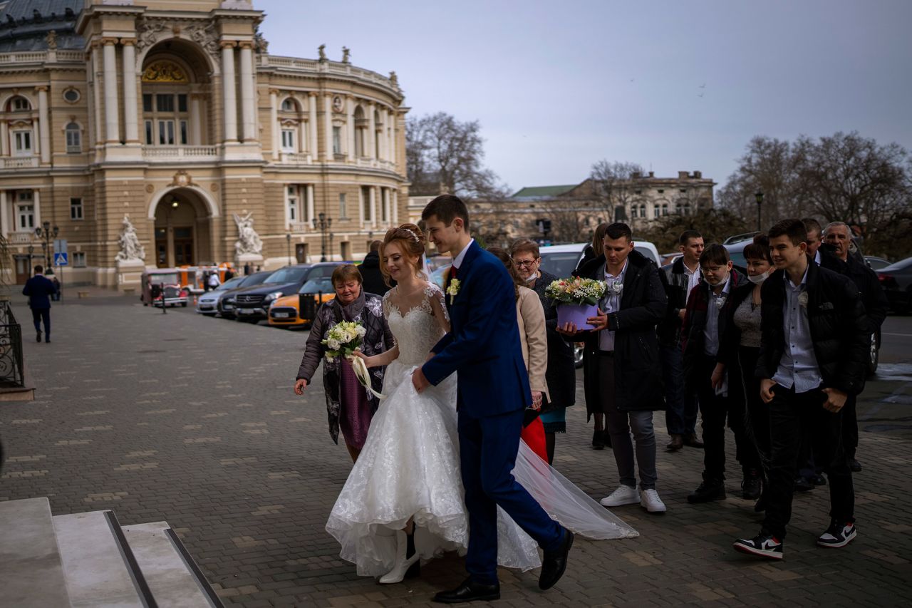 A couple arrives at the city council to get married in Odesa on February 20. As Ukrainian authorities reported further ceasefire violations and top Western officials warned about an impending conflict, life went on in other parts of the country.