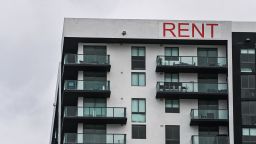 A "Rent" sign is displayed on an apartment building in Miami, Florida on January 20, 2022.