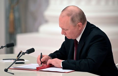 Putin signs decrees recognizing the Donetsk People's Republic and the Luhansk People's Republic in a ceremony in Moscow on February 21. Earlier in the day, the heads of the self-proclaimed pro-Russian republics requested the Kremlin leader recognize their independence and sovereignty. Members of Putin's Security Council supported the initiative in a meeting earlier in the day.
