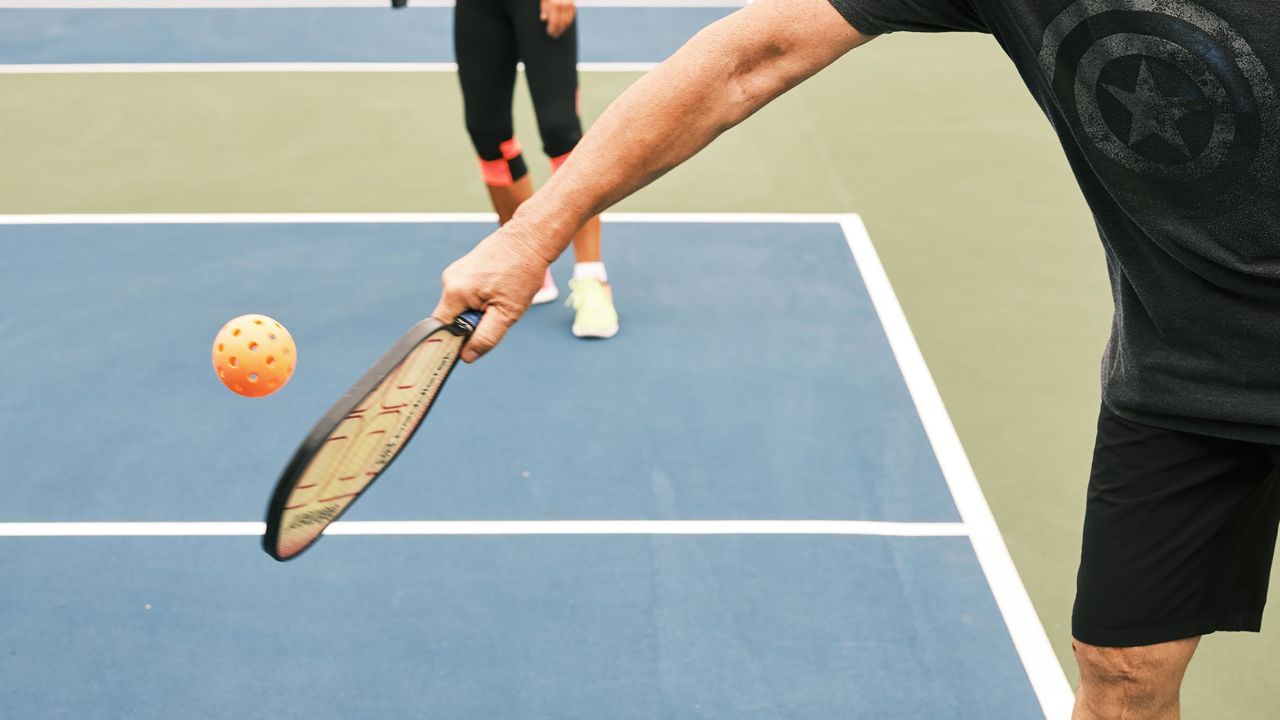 Players use paddles that are about double the size of ping pong paddles.