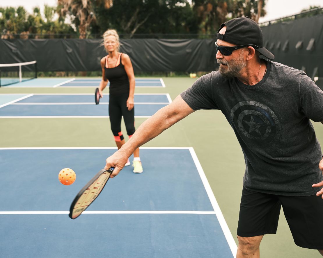 Players use paddles that are about double the size of ping pong paddles.