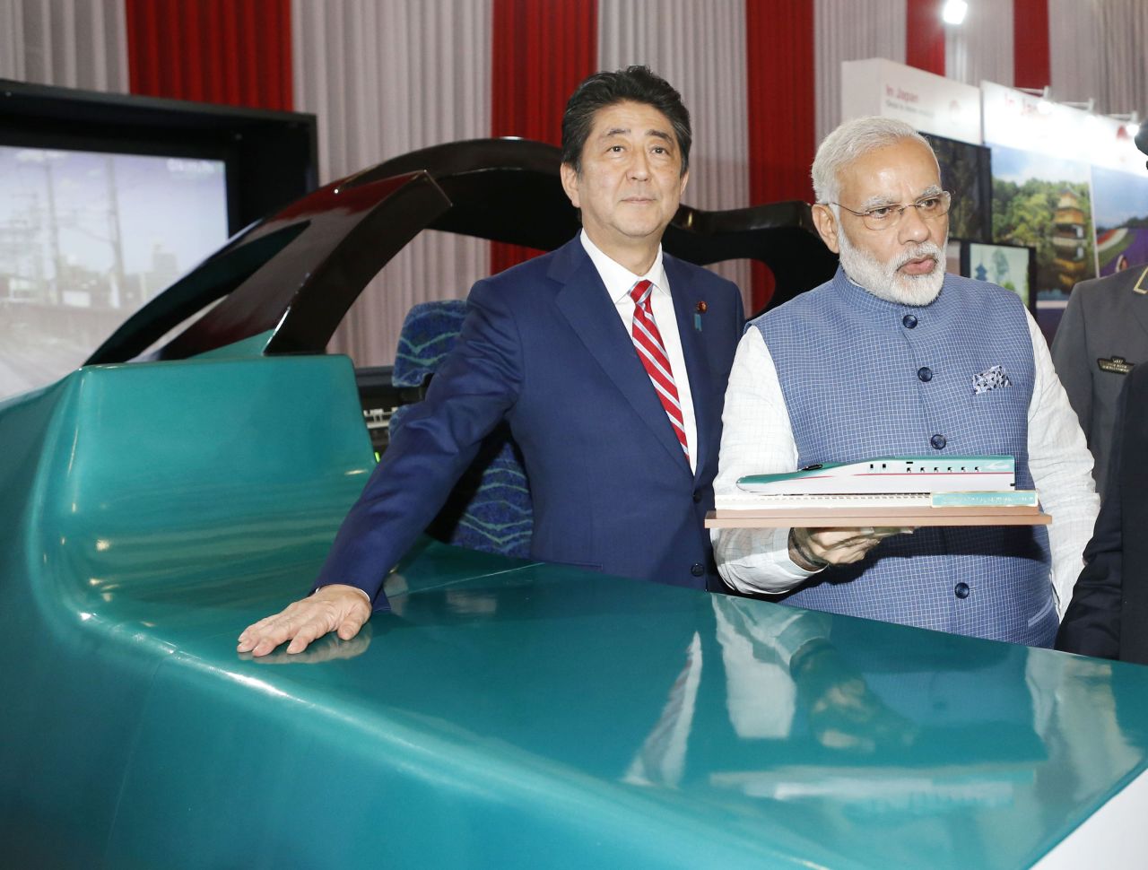 Former Japanese Prime Minister Shinzo Abe and Indian Prime Minister Narendra Modi pose in front of a high-speed train simulator in Gandhinagar, India, on September 14, 2017. 