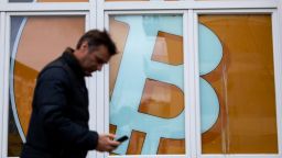 The logo of the Bitcoin cryptocurrency in a window of an office building in the Mitte district of Berlin, Germany, on Tuesday, Feb. 15, 2022. Waning turbulence and trading volume could spell trouble for crypto markets, where volatility is part of the appeal. Photographer: Krisztian Bocsi/Bloomberg via Getty Images
