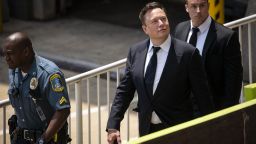 Elon Musk, chief executive officer of Tesla Inc., center, departs court during the SolarCity trial in Wilmington, Delaware, on Tuesday, July 13, 2021. 