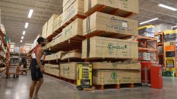 A customer walks past plywood for sale at a Home Depot store on May 27, 2021 in Doral, Florida. 