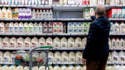 A shopper walks through the dairy aisle of a grocery store in Washington, DC, on February 19, 2022. 