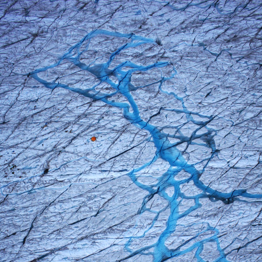 Meltwater on the surface of the ice sheet falls through cracks to the base.
