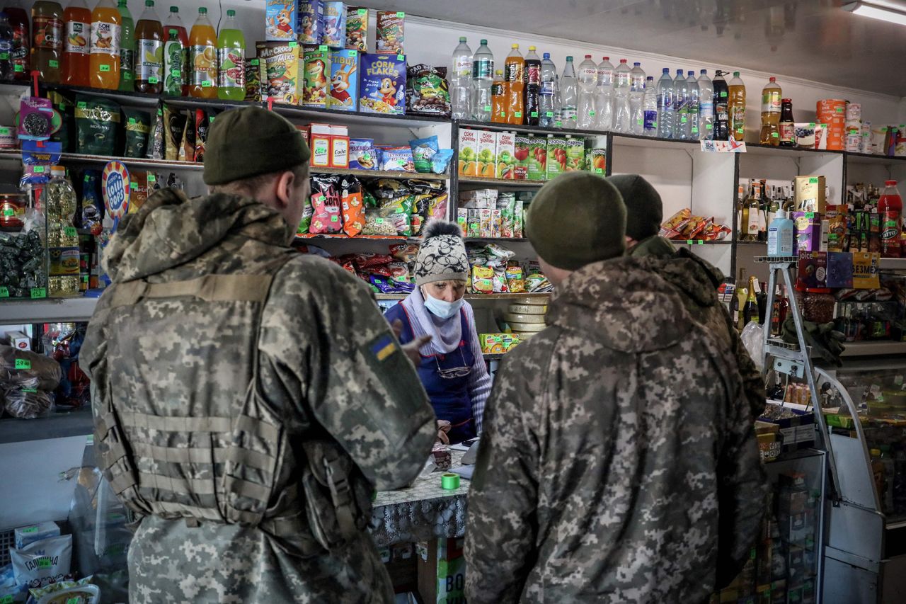 Ukrainian servicemen shop in the front-line town of Avdiivka, Ukraine, on February 21.  Zelensky says Russia waging war so Putin can stay in power &#8216;until the end of his life&#8217; w 1280