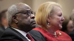 (L-R) Associate Supreme Court Justice Clarence Thomas sits with his wife and conservative activist Virginia Thomas while he waits to speak at the Heritage Foundation on October 21, 2021 in Washington, DC. 