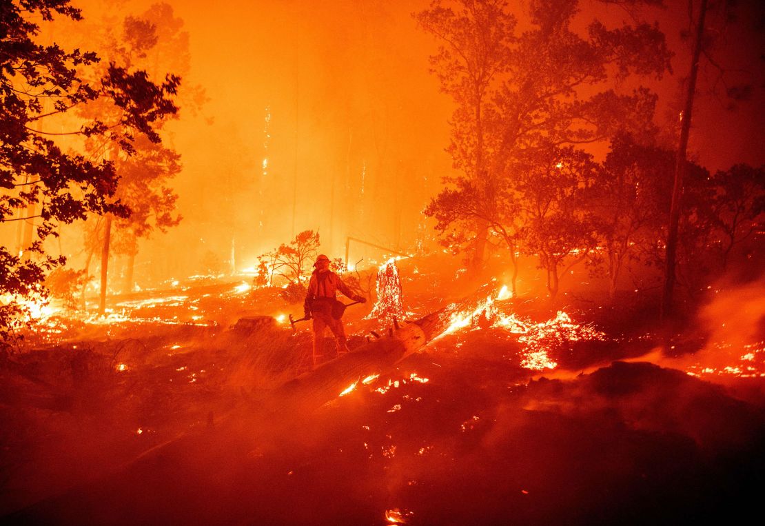 A firefighter battles flames during the Creek fire in the Cascadel Woods area of unincorporated Madera County, California, in  September 2020.