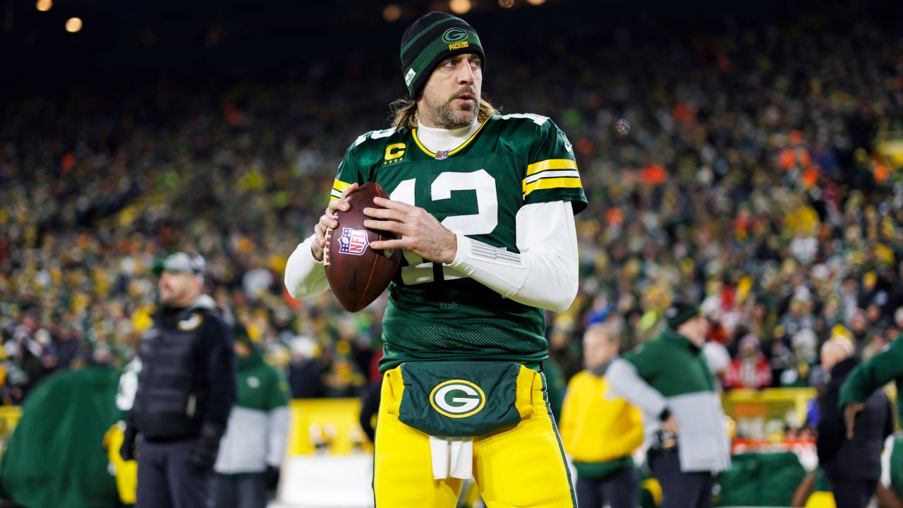 Rodgers throws a pass on the sideline prior to an NFL divisional playoff football game against the San Francisco 49ers.