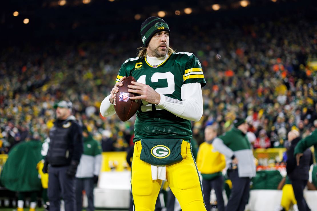 Rodgers throws a pass on the sideline prior to an NFL divisional playoff football game against the San Francisco 49ers.
