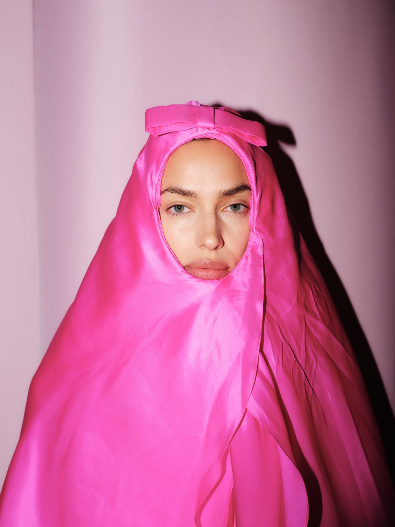 Irina Shayk strutted the runway in a fuscia pink shawl-dress.